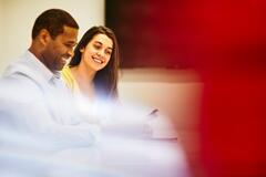 Smiling man and woman in an office
