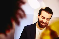 Close up - Smiling male looking down.
