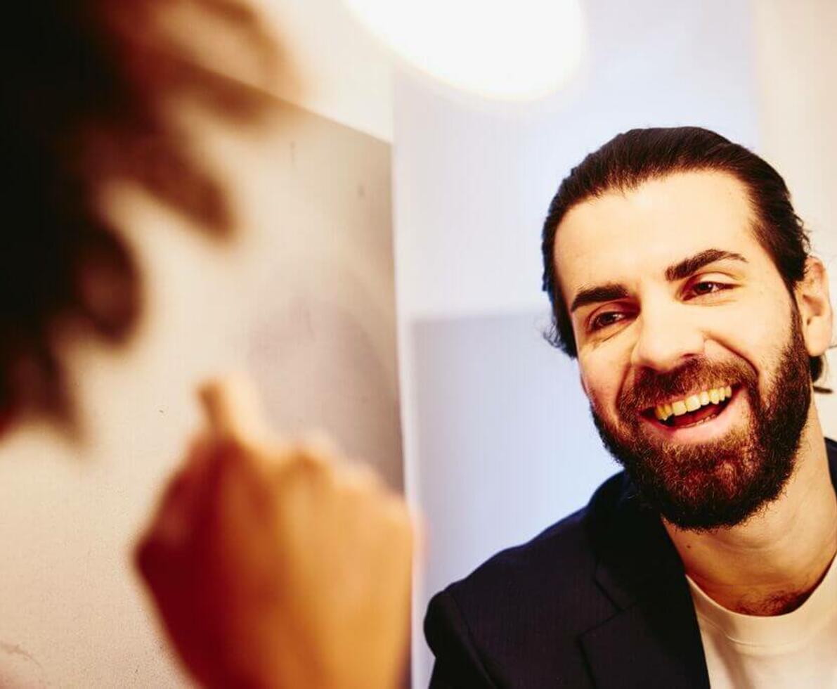 Close up - Smiling man looking at someone. mediation_voucher