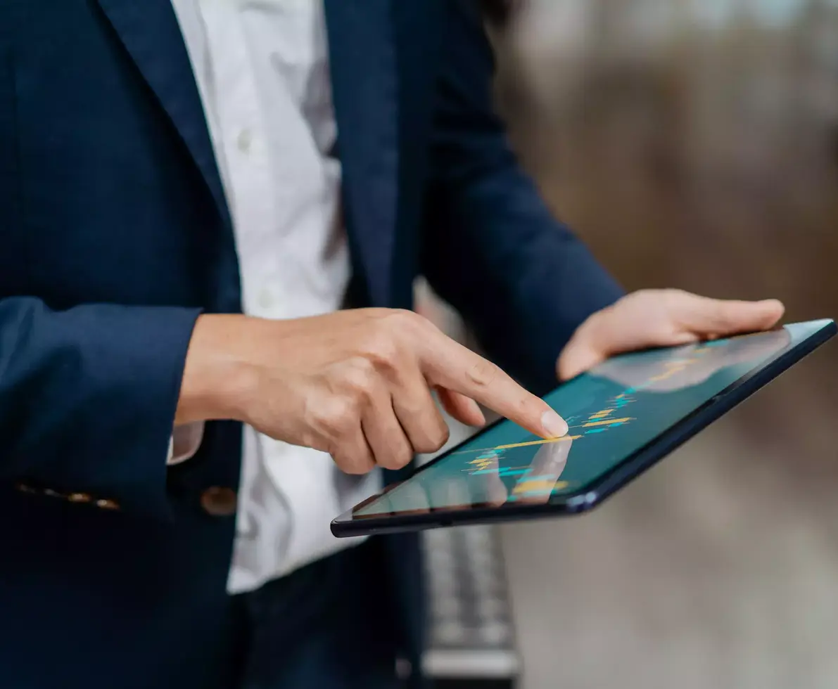 Image of an businessman checking stock market chart on digital tablet. Fund manager looking at stock market chart on digital tablet.