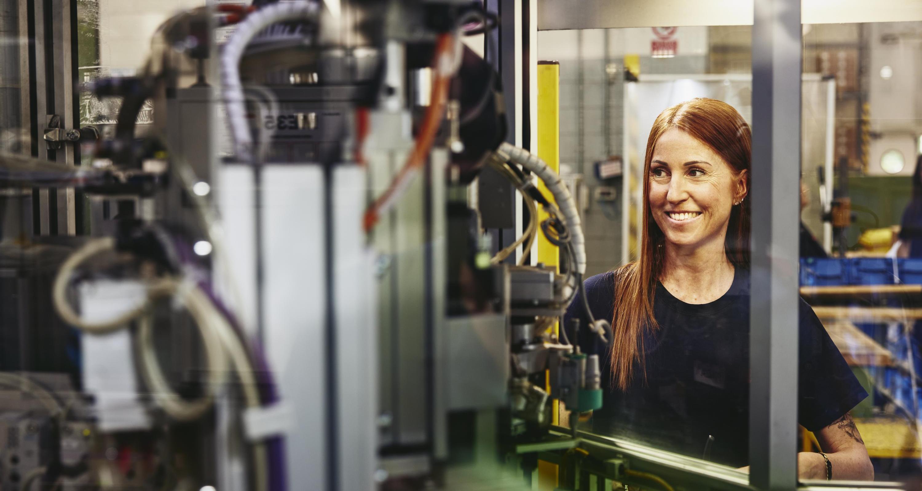 Woman operating a machine on a production site. 