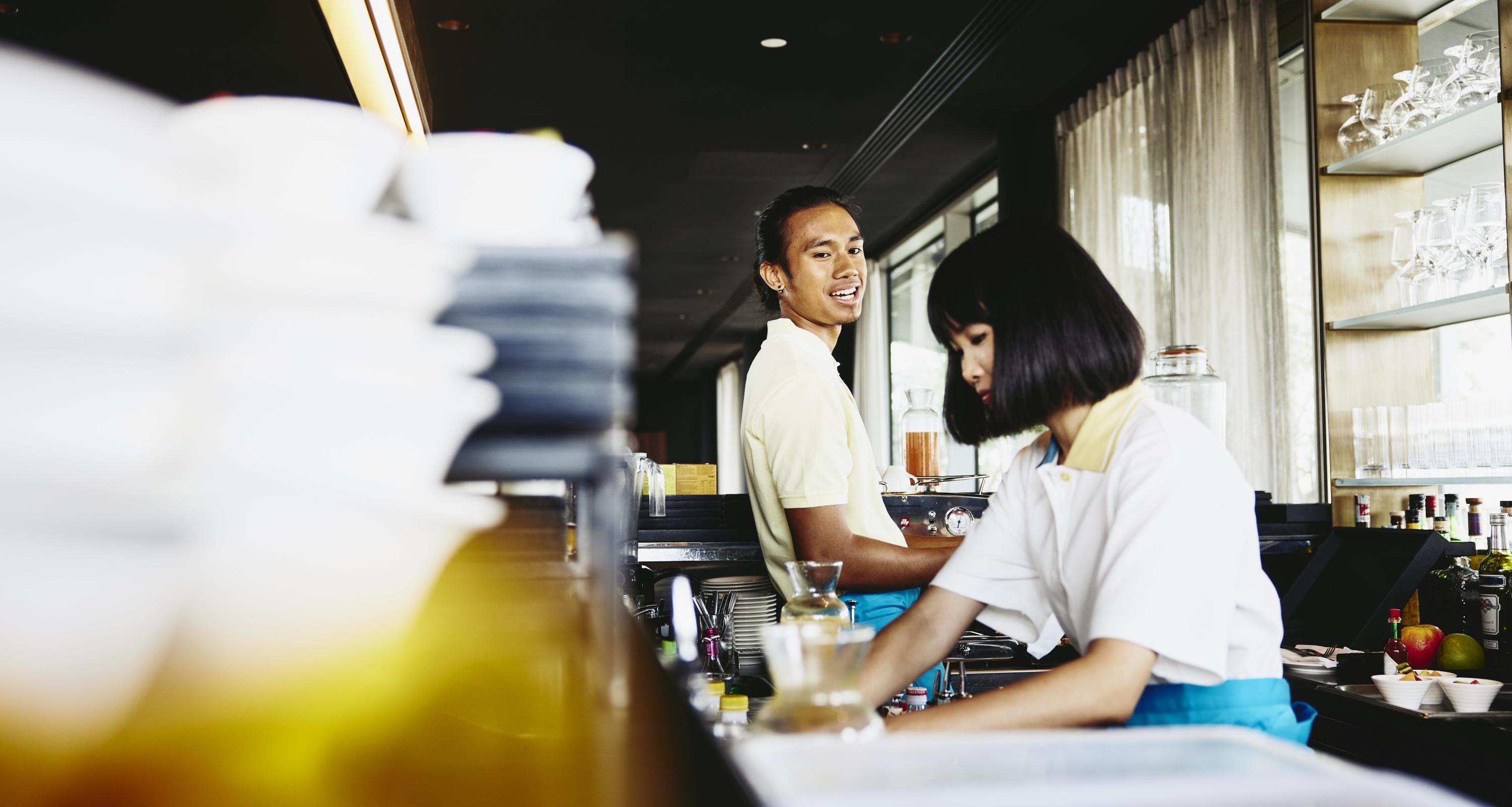Man and woman bar tending.