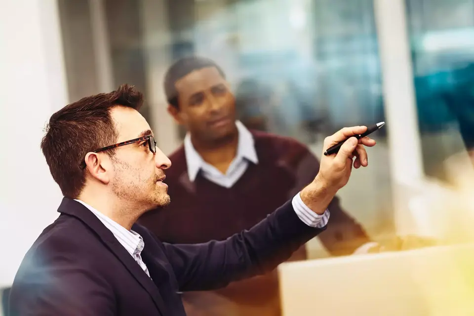 Two men working together in an office
