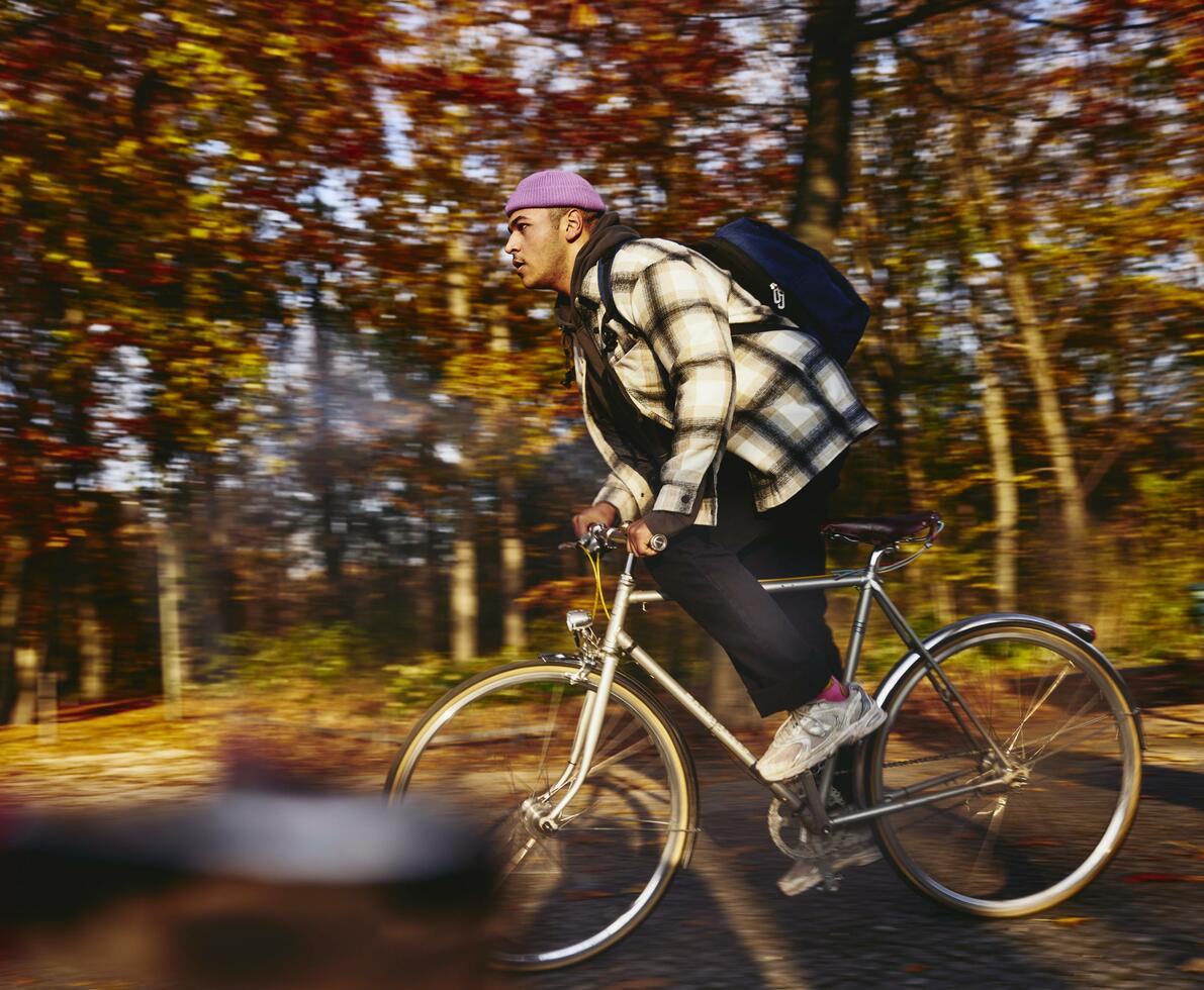 Cycling man, autumn trees on the background. growing